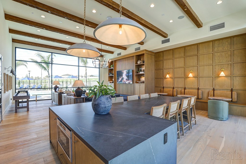 a large kitchen with a large island and a dining table  at Westbury Apartments, Rancho Cucamonga, CA