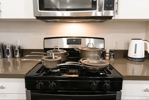 a kitchen stove with pots and pans on top of it