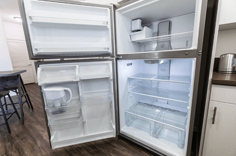 a refrigerator with its door open in a kitchen