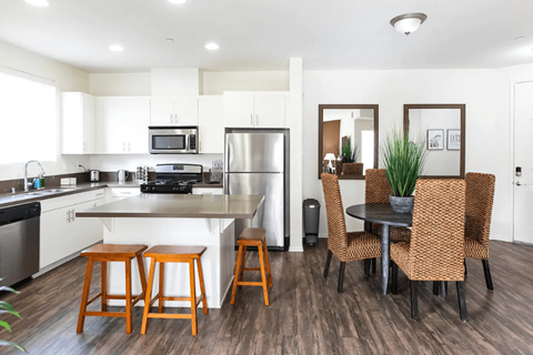a kitchen and dining area with a table and chairs