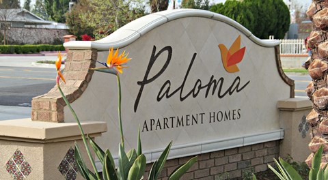 the sign for paloma apartment homes at the entrance of the property