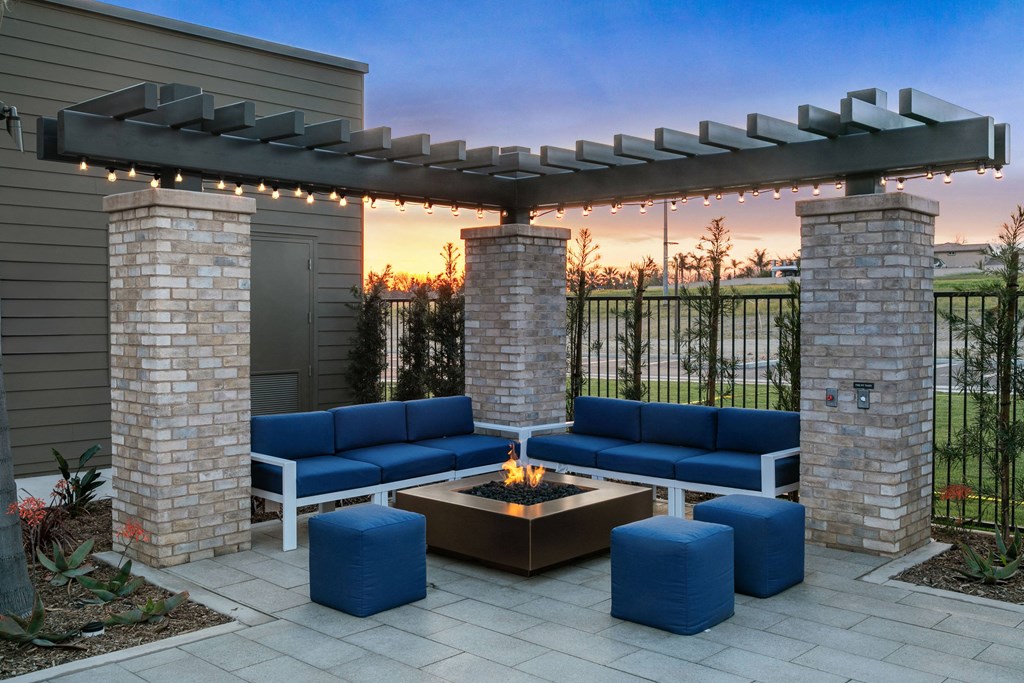 a patio with blue couches and a fire pitat Westbury Apartments, Rancho Cucamonga, California 