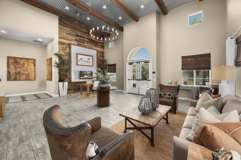 Spacious clubhouse lounge with high ceiling and seating at Paloma Apartment Homes, California