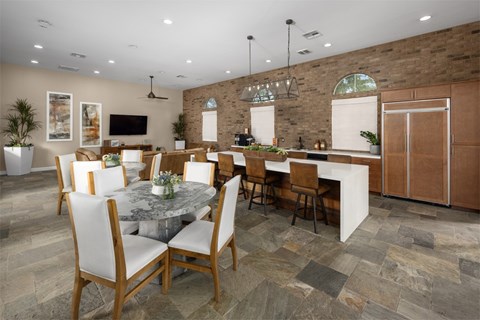 A modern dining room with a large table and chairs.