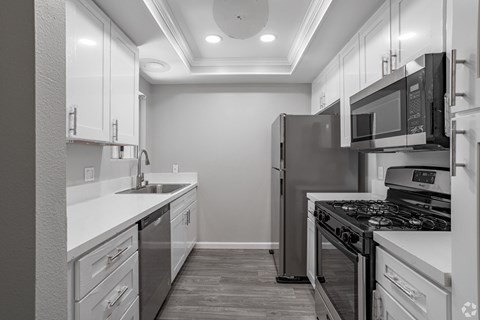 a kitchen with a stove and a sink in it