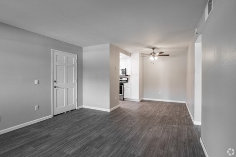 an empty living room with a sliding glass door