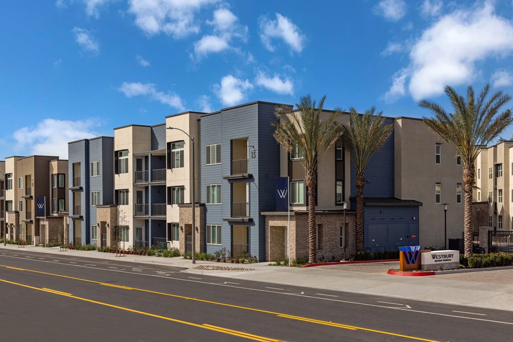 a street view of an apartment building with palm treesat Westbury Apartments, Rancho Cucamonga, California