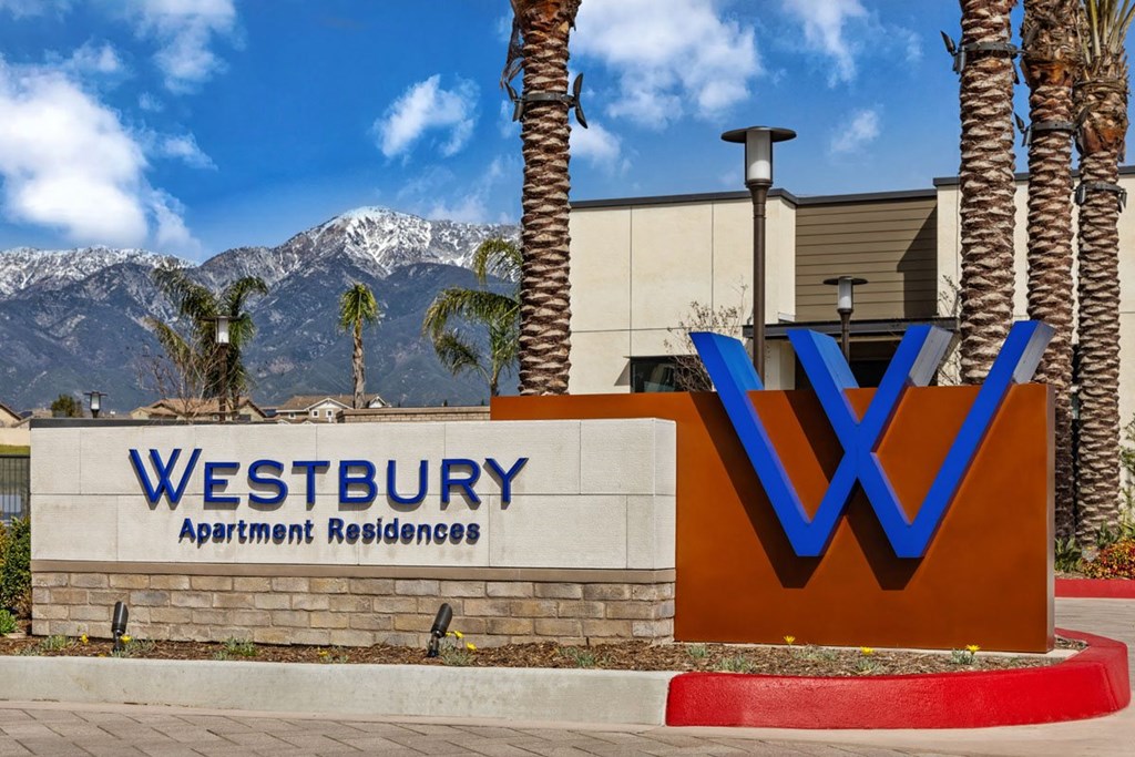 a sign for westbury apartment buildings with mountains in the backgroundat Westbury Apartments, Rancho Cucamonga, CA, 91739