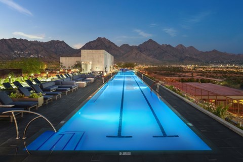 A long blue pool with a mountain in the background.