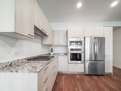 a kitchen with white cabinets and a stainless steel refrigerator