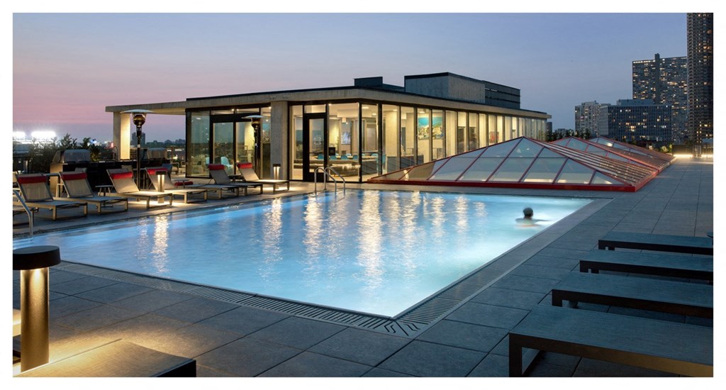 a swimming pool on the roof of a skyscraper