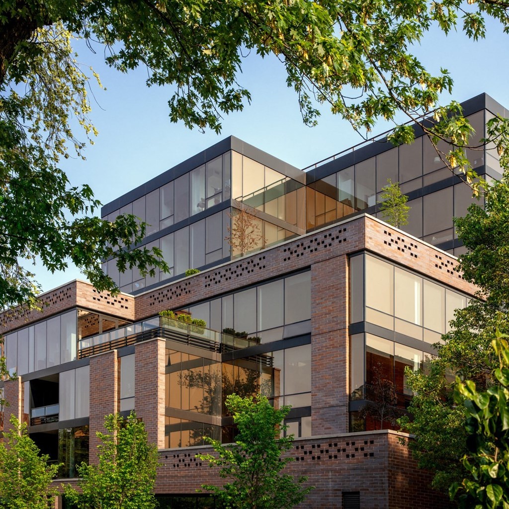 a view of a building with trees in front of it