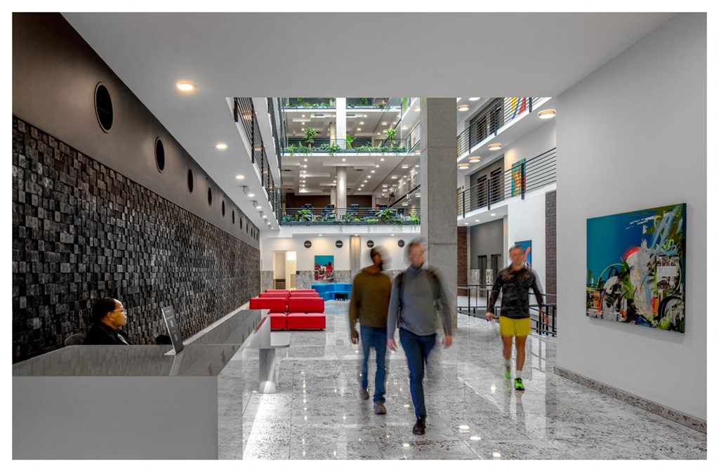 people walking through the lobby of a building