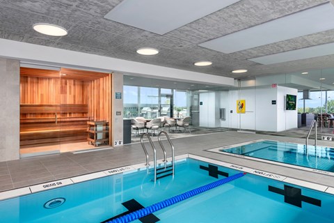 a swimming pool in a hotel lobby with a blue pool