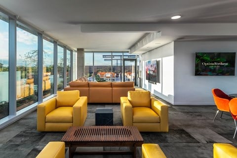 a living room with yellow couches and a table