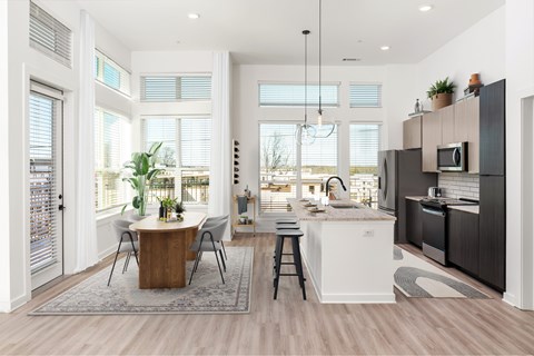 A modern kitchen with a dining table and chairs.