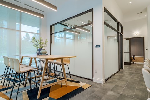 A modern dining room with a wooden table and chairs.