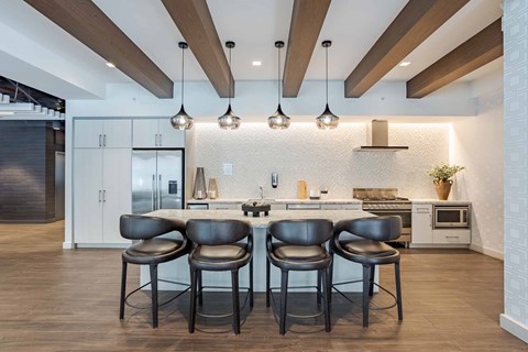 Two black chairs are in front of a kitchen island.
