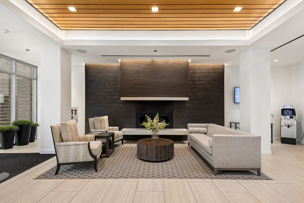 a living room with a fireplace and chairs