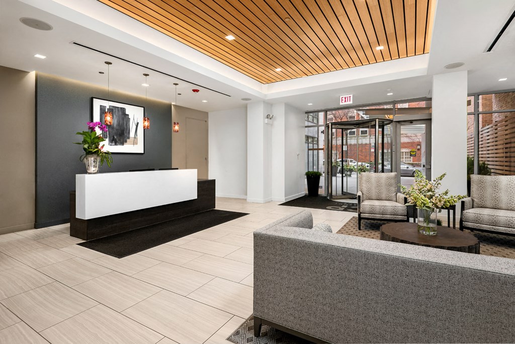 a lobby with a reception desk and chairs