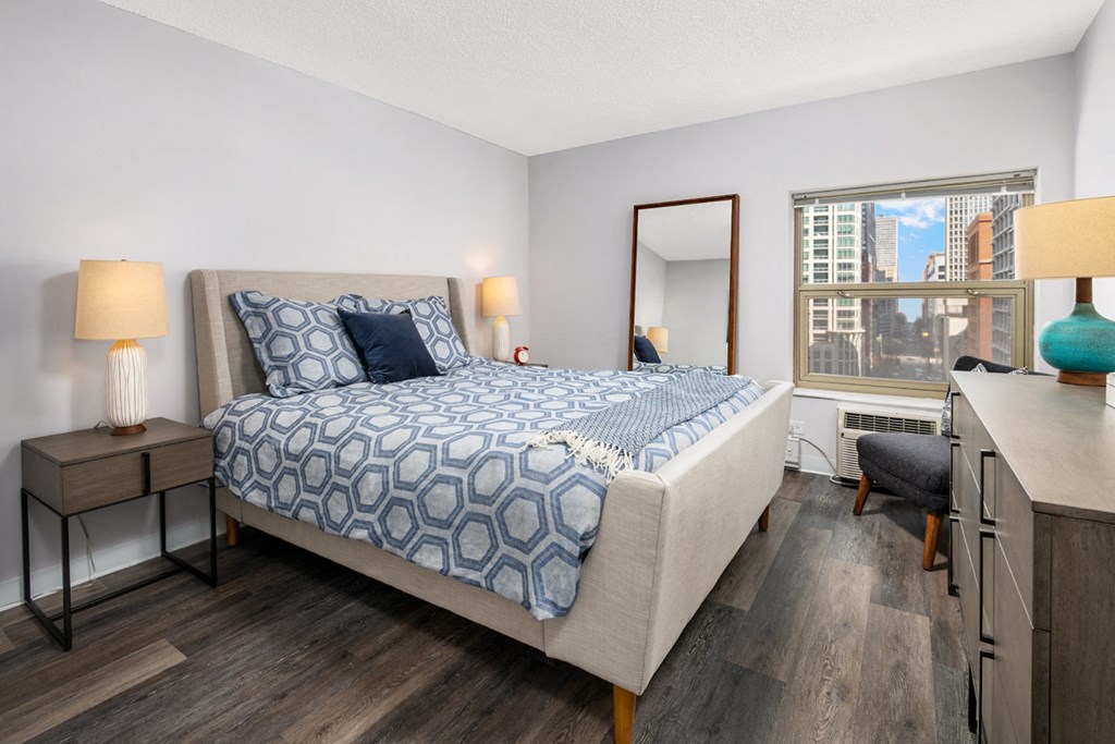 a bedroom with a large bed and a window