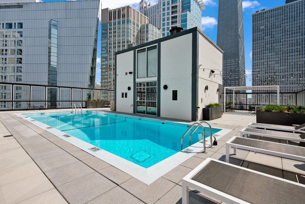 A swimming pool on a rooftop with a building in the background.