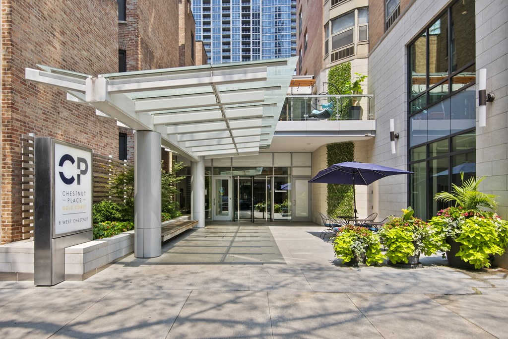 the entrance to a building with a walkway and a large glass door