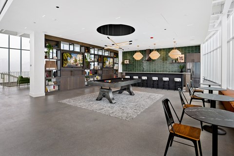 A modern dining area with a long table and chairs.