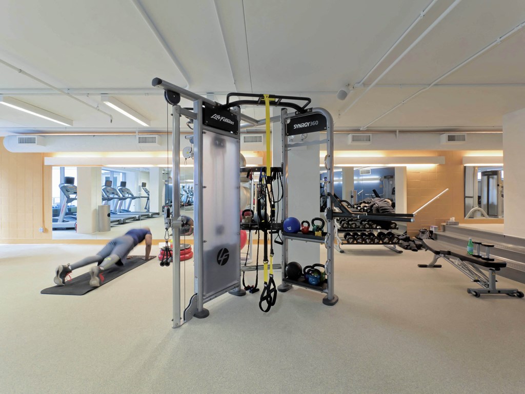 a gym with weights and other exercise equipment in a building