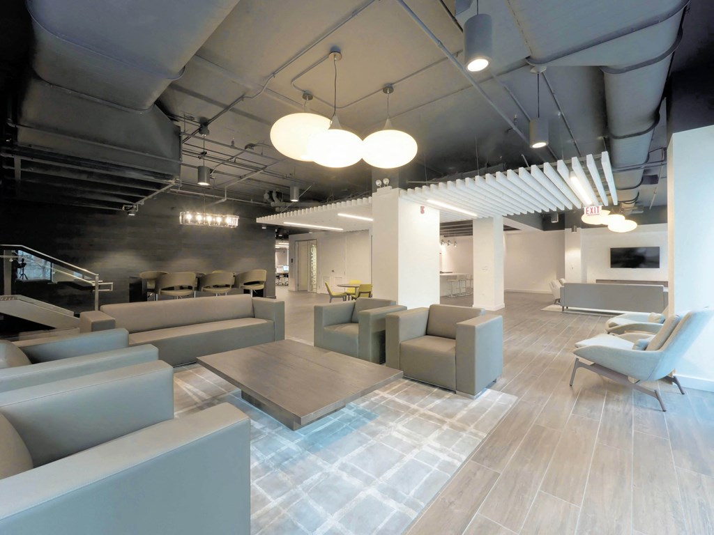 a lobby with couches and chairs and a table