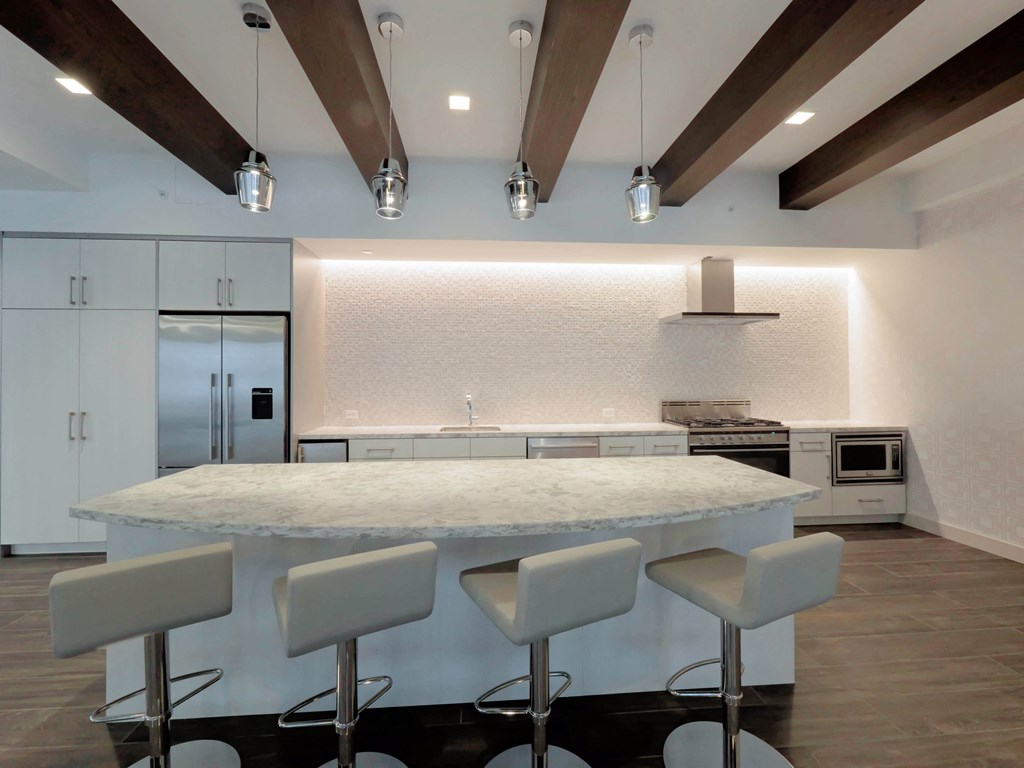 a kitchen with a marble counter top and white cabinets