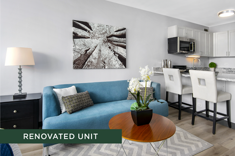 A renovated living space with a blue couch and a coffee table.