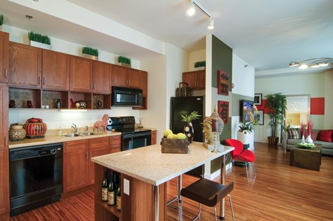 A kitchen with wooden cabinets and a white island.