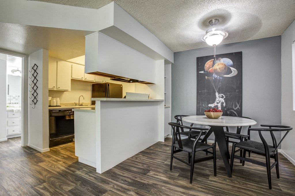 an open kitchen and dining room with a table and chairs and a kitchen counter top