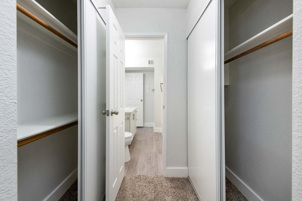 a bathroom with a toilet and a walk in closet