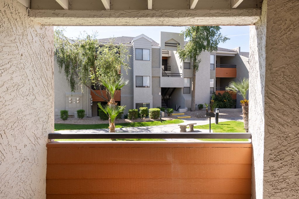 view from the window of an apartment building with a courtyard