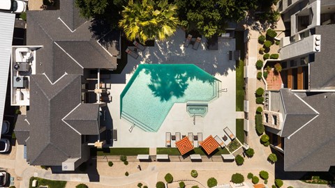an aerial view of a house with a swimming pool in the middle
