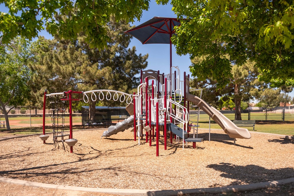 a playground with a assortment of playground equipment in a park