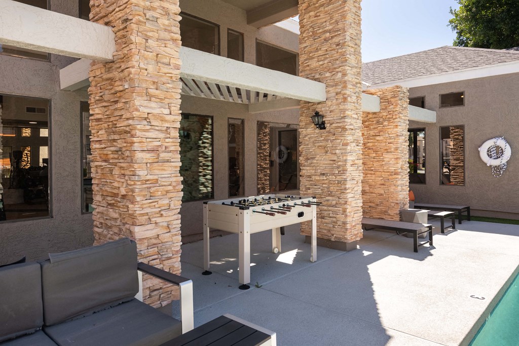 a foosball table in the backyard of a house