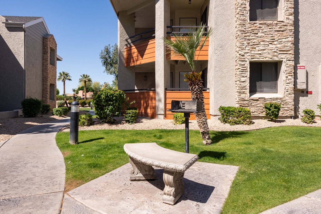 a stone bench sitting in front of a building