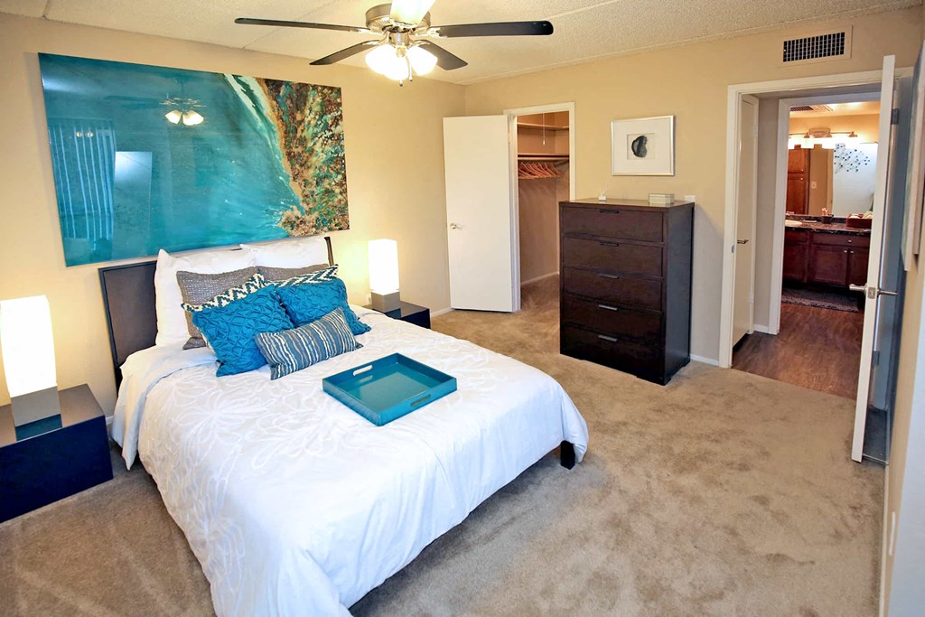 a bedroom with a bed and a ceiling fan