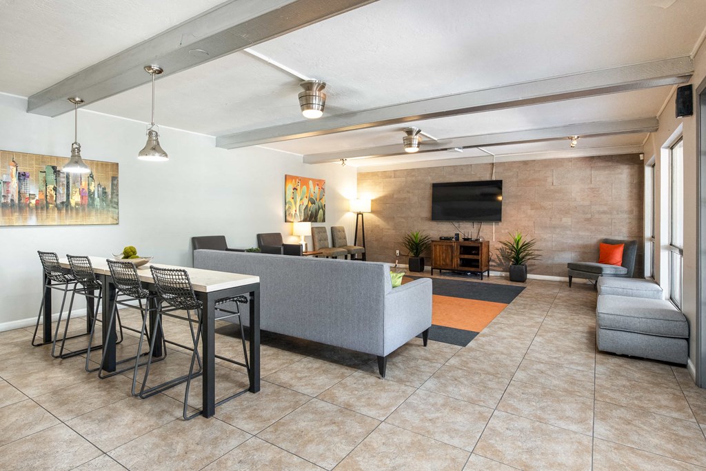 a living room with a couch and a table with chairs