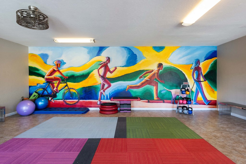 a wall mural in a room with a gym and exercise equipment