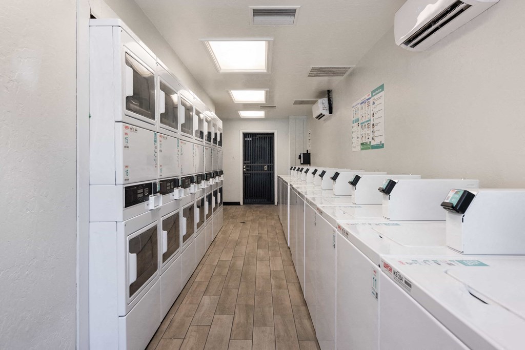 a white room with a row of microwaves on the counters