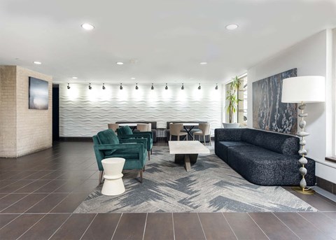 a lobby with couches and chairs and a table