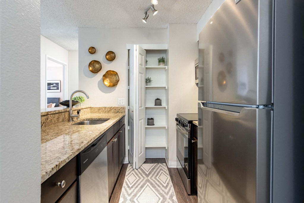 a kitchen with stainless steel appliances and granite counter tops