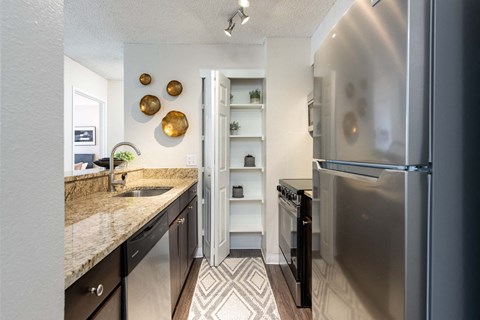 a kitchen with stainless steel appliances and granite counter tops