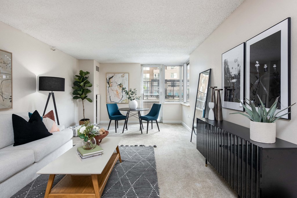 a living room with a white couch and a table and chairs