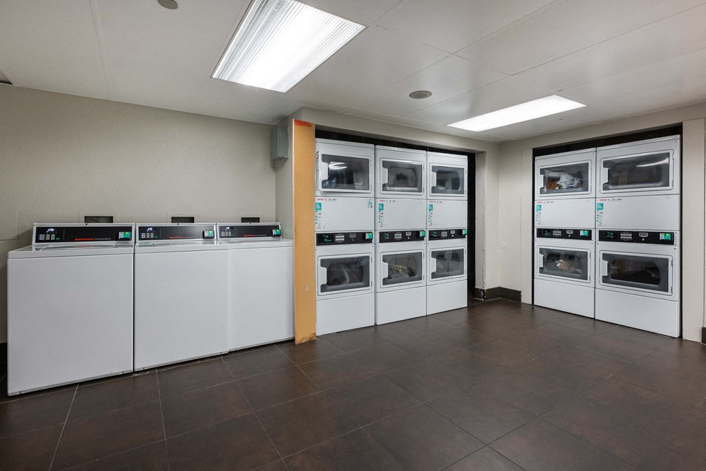 a laundry room with several washes and dryers in it