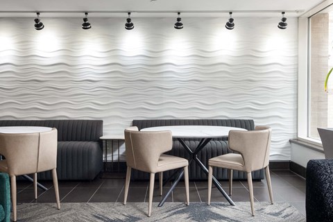 a table and chairs in a room with a white wall